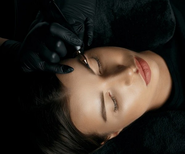 Client undergoing eyebrow microblading consultation